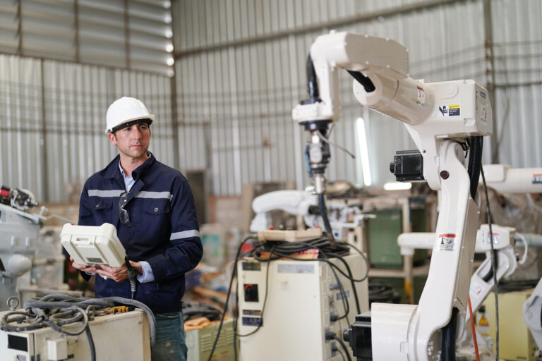 robotics engineer fitting sensors to traditional engineering lathe in robotics research facility